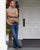 Model standing on the front porch of the Inns of Aurora, wearing Black Middle English handmade leather shoes by Aurora Shoe Co.